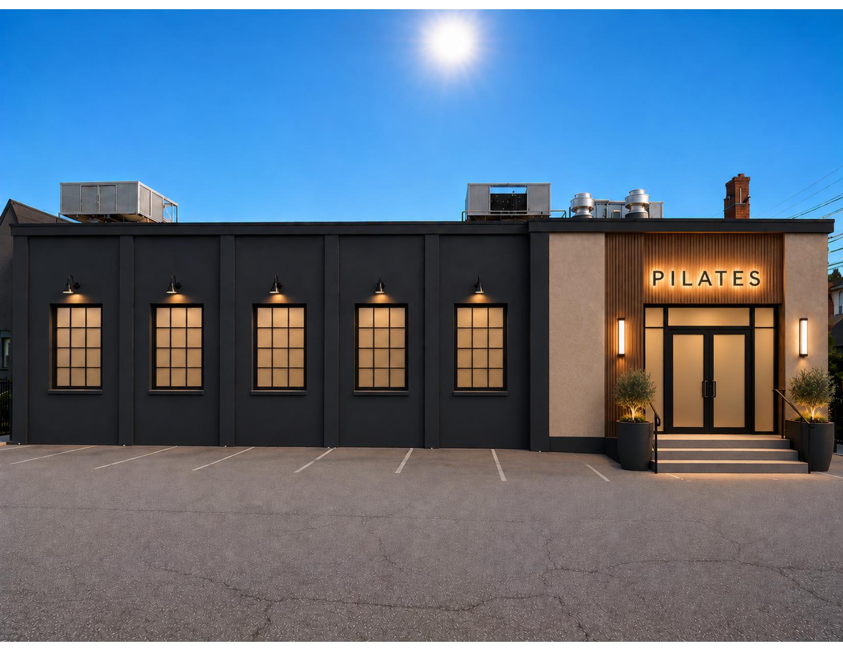 Rendering of the one-story building at 30 East State Street with a warm-lit entrance and parking